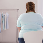 Stout young woman sitting on the chair